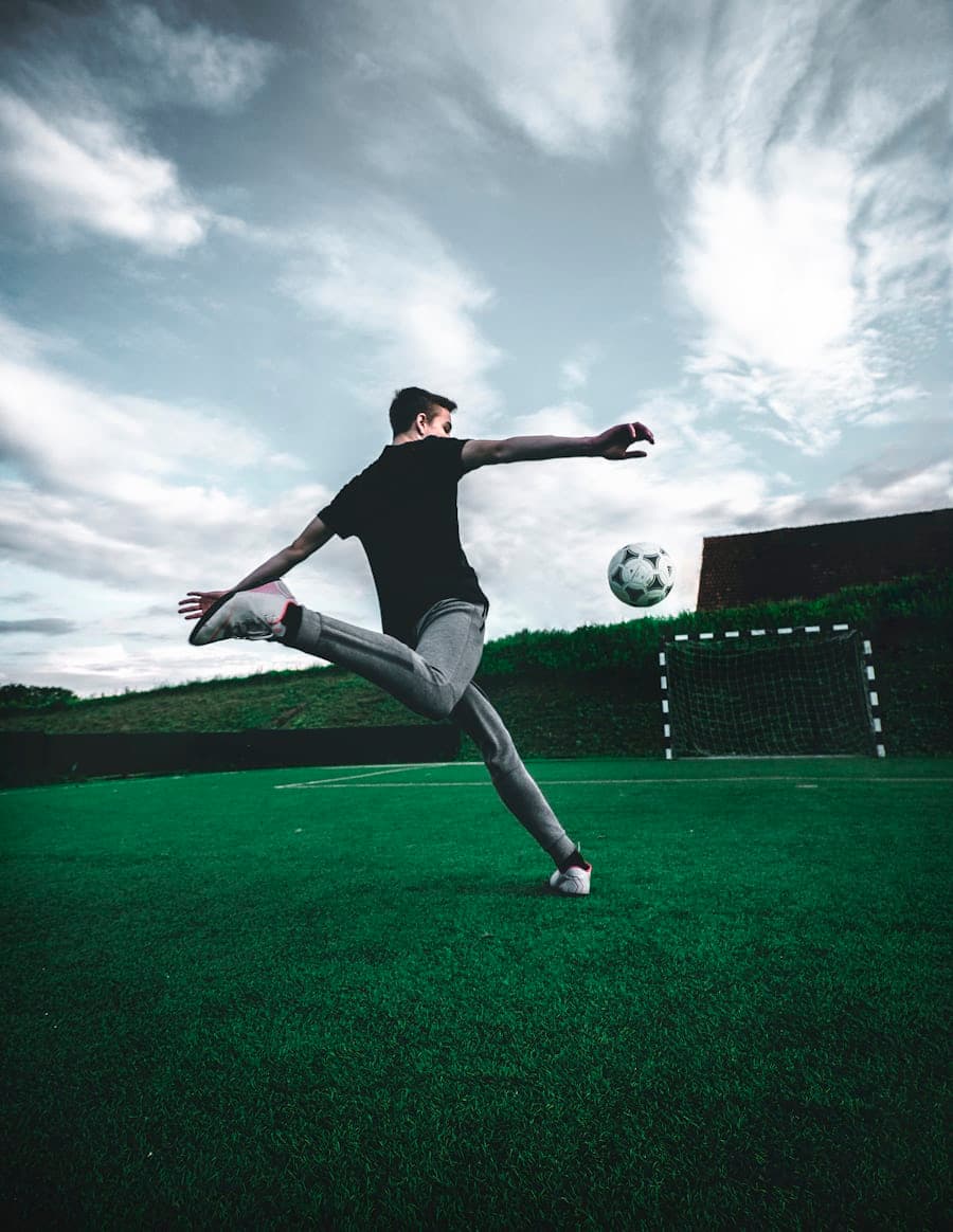 A player striking a ball on a small artificial pitch